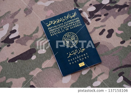 Algerian passport on table close up. Official identification document book for citizens of Algeria. Concept of travel and tourism 137158106