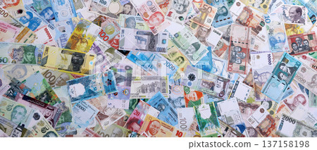 Different various money bills banknotes from random currencies of the world. Big pile of money bills close up 137158198