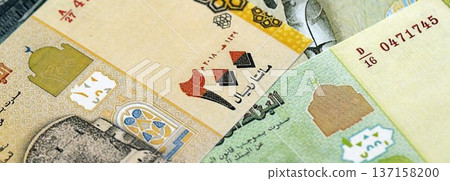 Yemeni rial paper banknotes pile on table. Yemen YER currency money bills in big amount. Concept of economics, taxation and banking in Yemen Yemeni rial paper banknotes pile on table. Yemen YER currency money bills in big amount. Concept of economics, taxation and banking in Yemen 137158200
