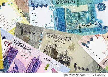 Sudanese pound paper banknotes pile on table. Sudan SDG currency money bills in big amount. Concept of economics, taxation and banking in Sudan 137158207