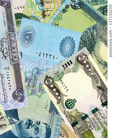 Iraqi dinar paper banknotes pile on table. Iraq IQD currency money bills in big amount. Concept of economics, taxation and banking in Iraq 137158209