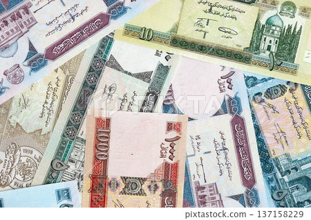 Afghan afghani paper banknotes pile on table. Afghanistan AFN currency money bills in big amount. Concept of economics, taxation and banking in Afghanistan 137158229