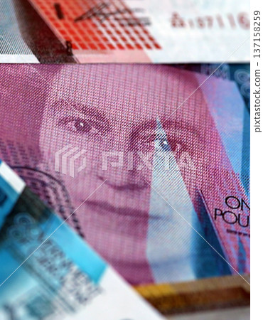 Gibraltar pound paper banknotes pile on table. Gibraltar GIP currency money bills in big amount. Concept of economics, taxation and banking in Gibraltar 137158259