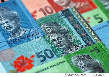 Malaysian ringgit paper banknotes pile on table. Malaysia MYR currency money bills in big amount. Concept of economics, taxation and banking in Malaysia Malaysian ringgit paper banknotes pile on table. Malaysia MYR currency money bills in big amount. Concept of economics, taxation and banking in Malaysia 137158260