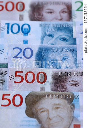 Swedish krona paper banknotes pile on table. Sweden SEK currency money bills in big amount. Concept of economics, taxation and banking in Sweden Swedish krona paper banknotes pile on table. Sweden SEK currency money bills in big amount. Concept of economics, taxation and banking in Sweden 137158264