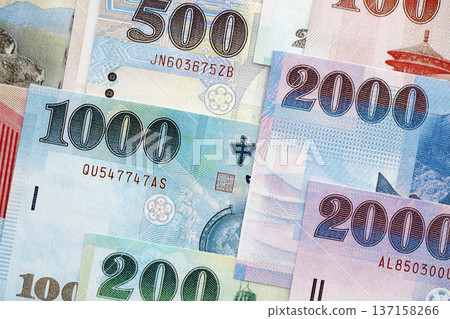 Taiwanese dollar paper banknotes pile on table. Taiwan TWD currency money bills in big amount. Concept of economics, taxation and banking in Taiwan Taiwanese dollar paper banknotes pile on table. Taiwan TWD currency money bills in big amount. Concept of economics, taxation and banking in Taiwan 137158266