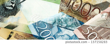 Kenyan shilling paper banknotes pile on table. Kenya KES currency money bills in big amount. Concept of economics, taxation and banking in Kenya Kenyan shilling paper banknotes pile on table. Kenya KES currency money bills in big amount. Concept of economics, taxation and banking in Kenya 137158283