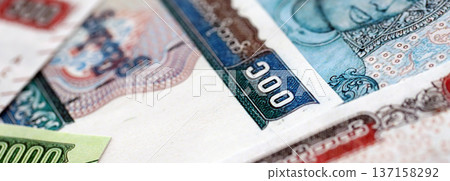 Myanmar kyat paper banknotes pile on table. Myanmar MMK currency money bills in big amount. Concept of economics, taxation and banking in Myanmar Myanmar kyat paper banknotes pile on table. Myanmar MMK currency money bills in big amount. Concept of economics, taxation and banking in Myanmar 137158292
