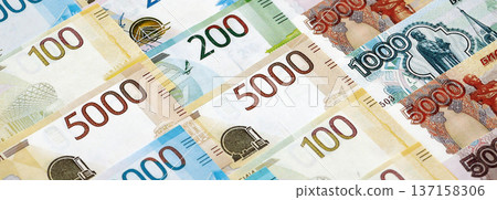 Russian ruble paper banknotes pile on table. Russia RUB currency money bills in big amount. Concept of economics, taxation and banking in Russia Russian ruble paper banknotes pile on table. Russia RUB currency money bills in big amount. Concept of economics, taxation and banking in Russia 137158306