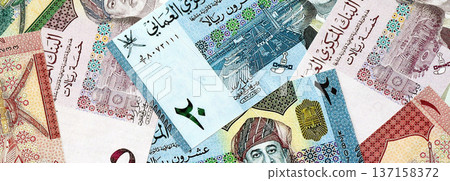 Omani rial paper banknotes pile on table. Oman OMR currency money bills in big amount. Concept of economics, taxation and banking in Oman 137158372