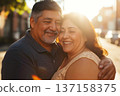 Happy Hispanic Senior Couple Embracing at Golden Hour 137158375