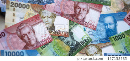 Big amount of chilean pesos money bills banknotes. Huge quantity of paper money from Chile country close up. Concept of business and economy in Chile Big amount of chilean pesos money bills banknotes. Huge quantity of paper money from Chile country close up. Concept of business and economy in Chile 137158385