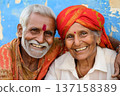 Happy elderly Indian couple smiling and embracing outdoors, expressing love, happiness, and vitality. 137158389