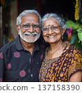 Happy elderly Indian couple smiling and embracing outdoors, expressing love, happiness, and vitality. 137158390