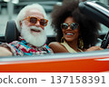 Cinematic photo of happy senior man with white beard and afro woman in cabriolet car. Happy moment concept 137158391