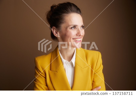 Thoughtful Businesswoman in Yellow Blazer 137158711