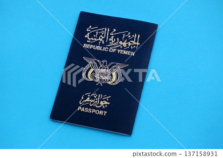 Yemeni passport on table close up. Official identification document book for citizens of Yemen. Concept of travel and tourism Yemeni passport on table close up. Official identification document book for citizens of Yemen. Concept of travel and tourism 137158931