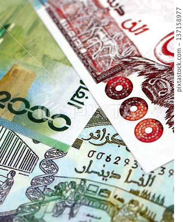 Algerian dinar paper banknotes pile on table. Algeria DZD currency money bills in big amount. Concept of economics, taxation and banking in Algeria Algerian dinar paper banknotes pile on table. Algeria DZD currency money bills in big amount. Concept of economics, taxation and banking in Algeria 137158977
