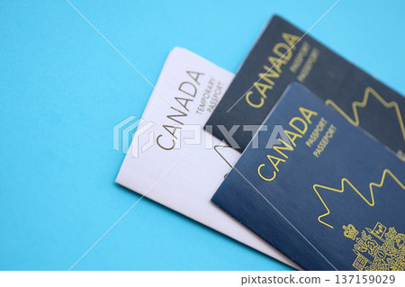 Canadian passports on table close up. Official identification document books for citizens of Canada. Concept of travel and tourism Canadian passports on table close up. Official identification document books for citizens of Canada. Concept of travel and tourism 137159029