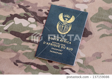 South African passport on table close up. Official identification document book for citizens of South Africa. Concept of travel and tourism South African passport on table close up. Official identification document book for citizens of South Africa. Concept of travel and tourism 137159086
