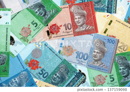 Malaysian ringgit paper banknotes pile on table. Malaysia MYR currency money bills in big amount. Concept of economics, taxation and banking in Malaysia Malaysian ringgit paper banknotes pile on table. Malaysia MYR currency money bills in big amount. Concept of economics, taxation and banking in Malaysia 137159098