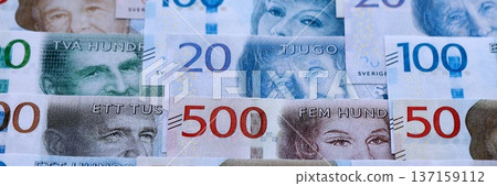 Swedish krona paper banknotes pile on table. Sweden SEK currency money bills in big amount. Concept of economics, taxation and banking in Sweden Swedish krona paper banknotes pile on table. Sweden SEK currency money bills in big amount. Concept of economics, taxation and banking in Sweden 137159112