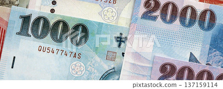 Taiwanese dollar paper banknotes pile on table. Taiwan TWD currency money bills in big amount. Concept of economics, taxation and banking in Taiwan 137159114