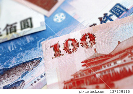 Taiwanese dollar paper banknotes pile on table. Taiwan TWD currency money bills in big amount. Concept of economics, taxation and banking in Taiwan Taiwanese dollar paper banknotes pile on table. Taiwan TWD currency money bills in big amount. Concept of economics, taxation and banking in Taiwan 137159116