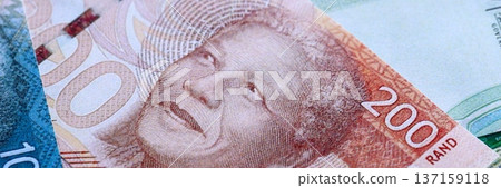 South African rand paper banknotes pile on table. South Africa ZAR currency money bills in big amount. Concept of economics, taxation and banking in South Africa South African rand paper banknotes pile on table. South Africa ZAR currency money bills in big amount. Concept of economics, taxation and banking in South Africa 137159118
