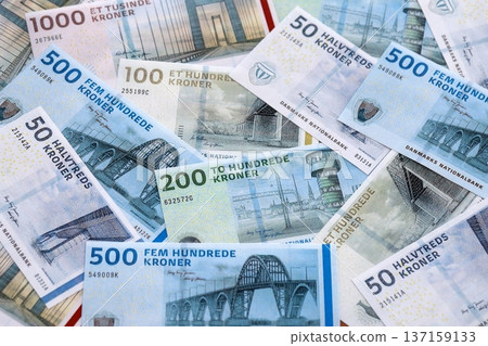 Danish krone paper banknotes pile on table. Denmark DKK currency money bills in big amount. Concept of economics, taxation and banking in Denmark Danish krone paper banknotes pile on table. Denmark DKK currency money bills in big amount. Concept of economics, taxation and banking in Denmark 137159133