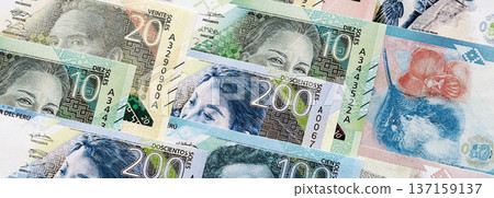 Peruvian sol paper banknotes pile on table. Peru PEN currency money bills in big amount. Concept of economics, taxation and banking in Peru Peruvian sol paper banknotes pile on table. Peru PEN currency money bills in big amount. Concept of economics, taxation and banking in Peru 137159137