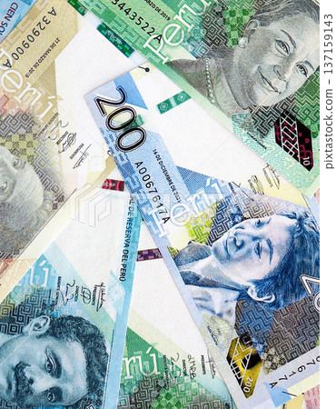 Peruvian sol paper banknotes pile on table. Peru PEN currency money bills in big amount. Concept of economics, taxation and banking in Peru Peruvian sol paper banknotes pile on table. Peru PEN currency money bills in big amount. Concept of economics, taxation and banking in Peru 137159143
