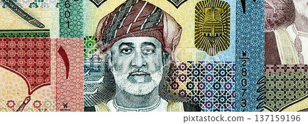 Omani rial paper banknotes pile on table. Oman OMR currency money bills in big amount. Concept of economics, taxation and banking in Oman Omani rial paper banknotes pile on table. Oman OMR currency money bills in big amount. Concept of economics, taxation and banking in Oman 137159196