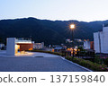 Night view of rest facilities and street lights with mountains in the background 137159840