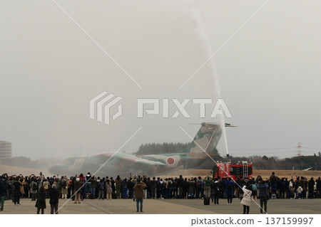 A C-1 transport plane passes through a water cannon at a retirement ceremony. A C-1 transport plane passes through a water cannon at a retirement ceremony. 137159997