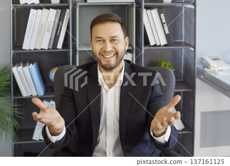 Smiling businessman gesturing to camera during remote office video meeting 137161125