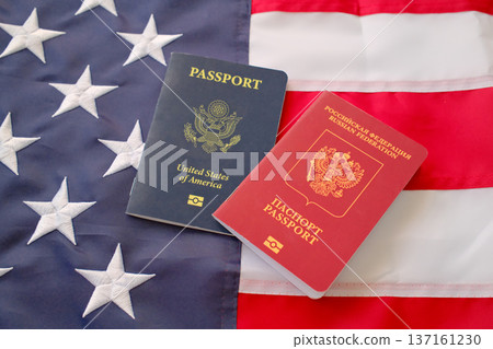 United States and Russian passports on American flag background, dual citizenship and international travel concept United States and Russian passports on American flag background, dual citizenship and international travel concept 137161230