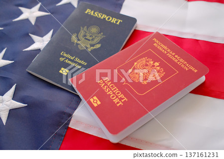 United States and Russian passports on American flag background, dual citizenship and international travel concept 137161231