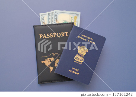 India passport with US dollar banknotes in leather cover on gray background, travel and immigration finance concept India passport with US dollar banknotes in leather cover on gray background, travel and immigration finance concept 137161242