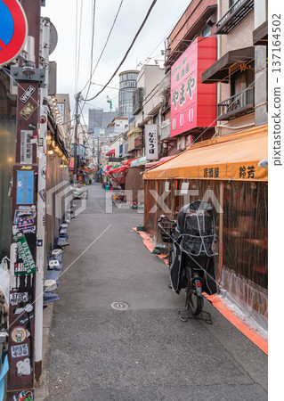 Narrow street with shops and bicycle in urban area, Japan Narrow street with shops and bicycle in urban area, Japan 137164502