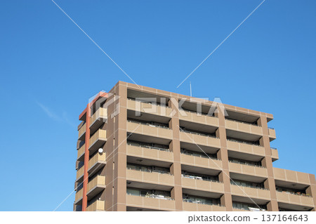 A sunny day with blue skies and an apartment building A sunny day with blue skies and an apartment building 137164643