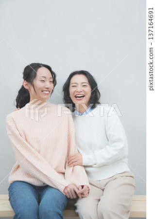 Retro-inspired portrait of a close mother and daughter Retro-inspired portrait of a close mother and daughter 137164691