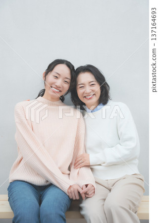 Retro-inspired portrait of a close mother and daughter Retro-inspired portrait of a close mother and daughter 137164693