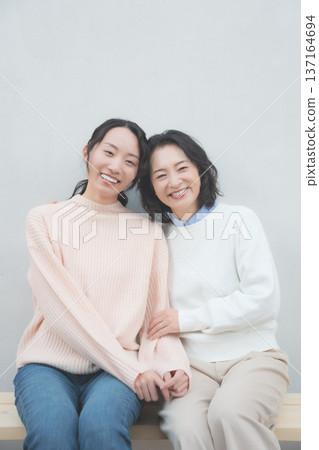 Retro-inspired portrait of a close mother and daughter Retro-inspired portrait of a close mother and daughter 137164694