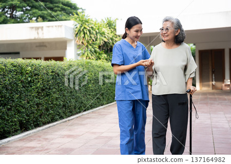 Asian caregivers provide compassionate assistance to seniors, ensuring quality elderly care. Their service supports health and well-being, reflecting the dedication in nursing homes for retirees. Asian caregivers provide compassionate assistance to seniors, ensuring quality elderly care. Their service supports health and well-being, reflecting the dedication in nursing homes for retirees. 137164982