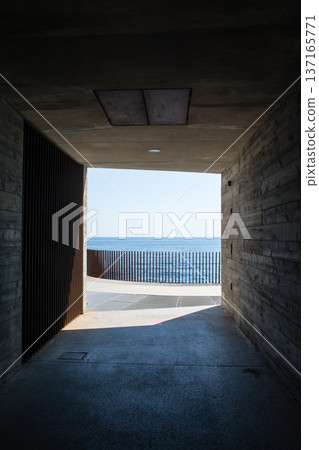 The Mediterranean horizon seen beyond a square pedestrian tunnel on the French island of Corsica in the Mediterranean Sea The Mediterranean horizon seen beyond a square pedestrian tunnel on the French island of Corsica in the Mediterranean Sea 137165771