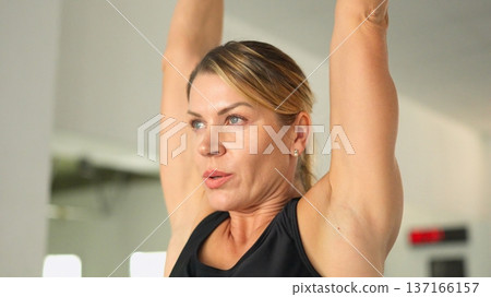 Woman staying active and focused during fitness workout Woman staying active and focused during fitness workout 137166157