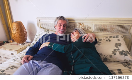 Senior couple sharing happy intimate moments in bed Senior couple sharing happy intimate moments in bed 137166278