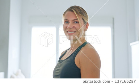 Woman smiling after fitness workout exercising at home Woman smiling after fitness workout exercising at home 137166287