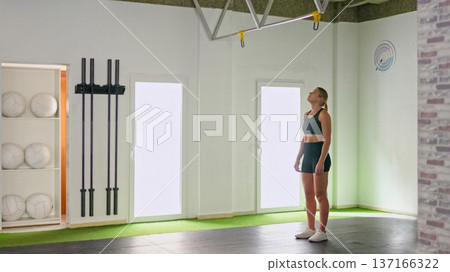 Young woman preparing to climb on the bar 137166322